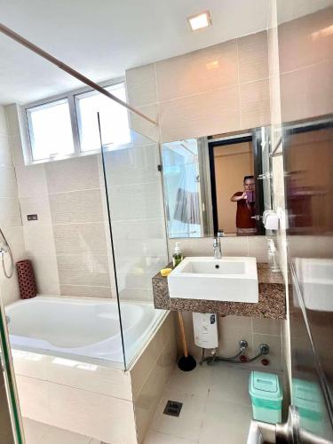 ein Badezimmer mit einer weißen Badewanne und einem Waschbecken in der Unterkunft SeaBu Properties in Lapu Lapu City