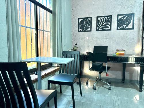 a table and chairs in a room with a window at Habitaciones Dos Antonios in Puerto Vallarta