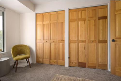 a room with wooden closet doors and a chair at 70s Time Capsule 2-min walk to main ski In out in Park City