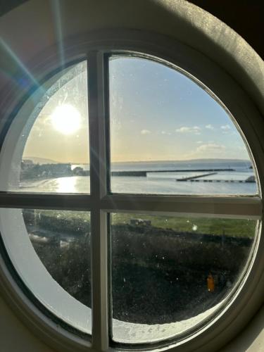a view of the ocean through a window at Church Bay House in Rathlin Island