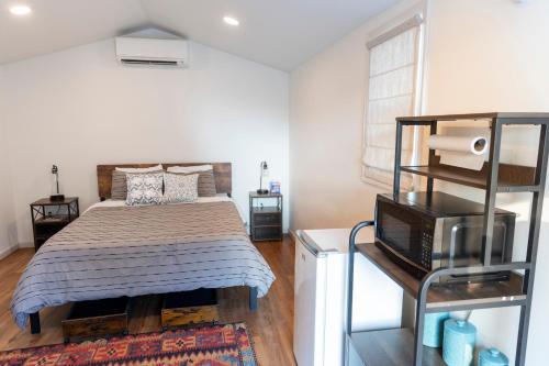 a bedroom with a bed and a television in it at Black Hills Station in Piedmont