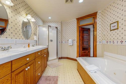 a bathroom with a tub and a sink and a shower at Columbia Falls Ranch Living in Columbia Falls