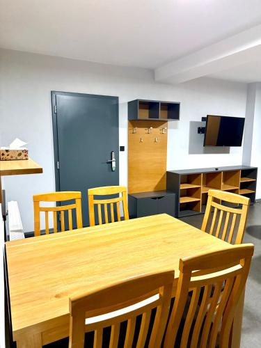 a dining room with a wooden table and chairs at Resort Mezná in Hřensko