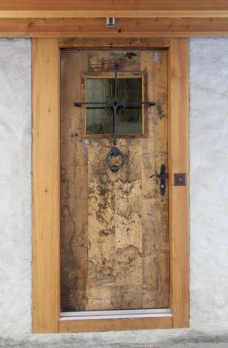 a wooden door with a window on a building at Ferienwohnung Chalet Püzji in Zermatt