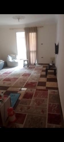 a living room with a tile floor and a window at for calmness lovers and relax in Alexandria