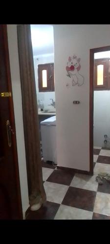 a kitchen with a refrigerator with a cow on the wall at for calmness lovers and relax in Alexandria