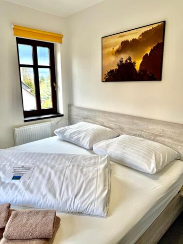 a bedroom with two beds and a window at Resort Mezná in Hřensko