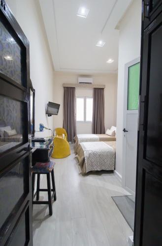 a hotel room with a bed and a tv at Mamora Bay in Tangier