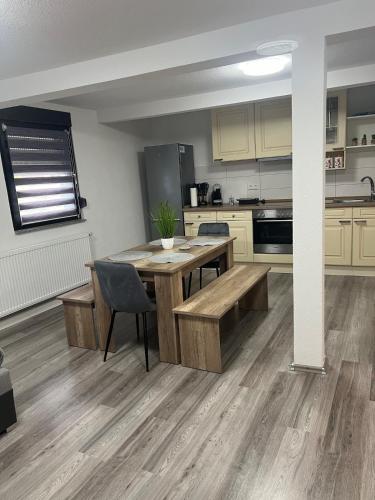 a large kitchen with a wooden table and chairs at Apartment in Hügelsheim in Hügelsheim