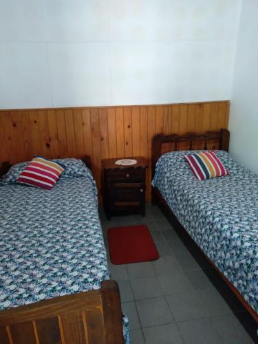 two beds sitting next to each other in a room at Departamentos Calamuchita in Santa Rosa de Calamuchita
