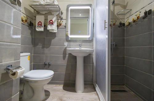 a small bathroom with a toilet and a sink at Mamora Bay in Tangier