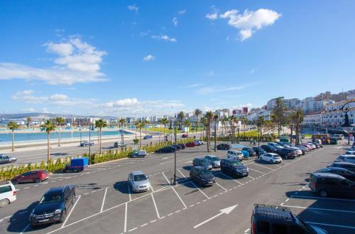 a parking lot with many cars parked in it at Mamora Bay in Tangier