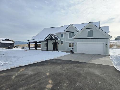 a large white house with a garage at Sky Sapphire Haven in Fish Haven