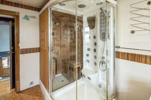 a shower with a glass door in a bathroom at Huge 6 Beds House in Zone 2 London-MobileRateOffers-Families-Leisure-Parking-WiFi-PoolTable-Netflix-Sleeps15! in London