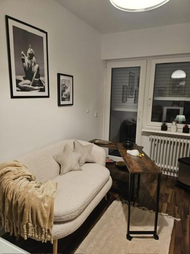 a living room with a couch and a wooden table at Ferienwohnung AM HOCHBERG in Bad Kissingen