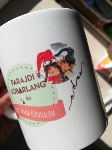 a cup with a picture of two people on it at Sailor Apartman Balatonlelle in Balatonlelle