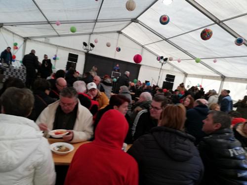 a crowd of people sitting at a table in a tent at Sailor Apartman Balatonlelle in Balatonlelle