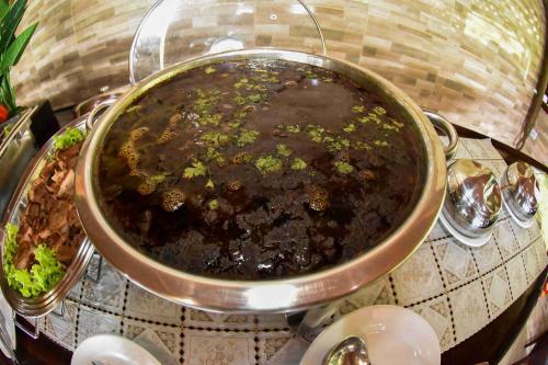 a large pot of food sitting on a table at Evolução Ecolodge in Iranduba
