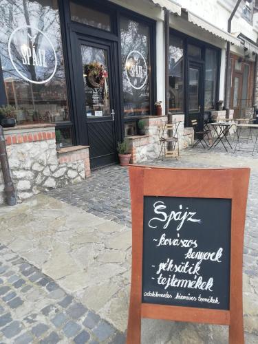a sign sitting in front of a restaurant at Sailor Apartman Balatonlelle in Balatonlelle