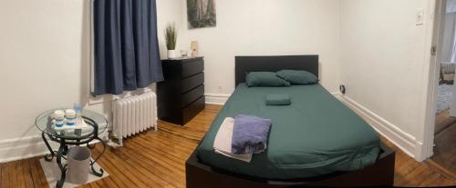 a bedroom with a bed and a table in it at Banlieue Pillars Maison in Mount Vernon