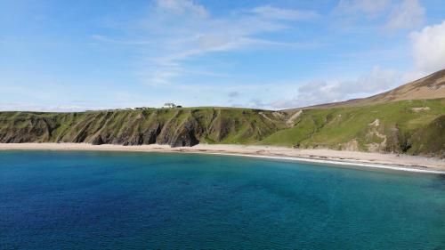 an aerial view of a beach with blue water at The Limehouse Cottage in Killybegs