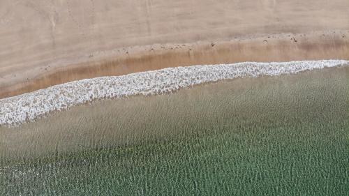 an aerial view of the beach and the ocean at The Limehouse Cottage in Killybegs