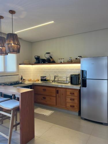 a kitchen with a white refrigerator and a table at Sunny Kite House Prea in Prea