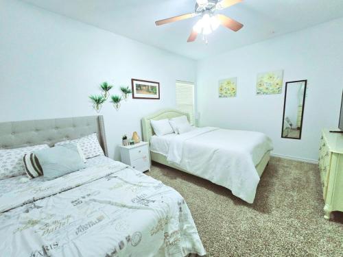 a bedroom with two beds and a ceiling fan at Home-away-from-Home in Odessa