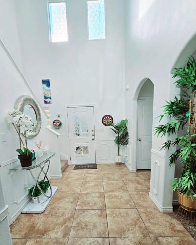a room with white walls and a tile floor with plants at Home-away-from-Home in Odessa