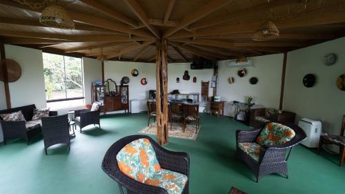 a living room with chairs and a large umbrella at Evolução Ecolodge in Iranduba