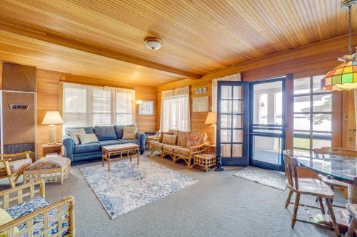 a living room with a couch and a table at Waterfront Alanson Cottage with Dock and Lake Access! in Alanson