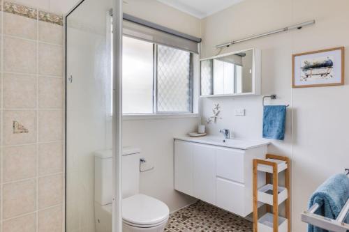 a bathroom with a toilet and a shower at Kaimai House in South West Rocks
