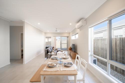 a dining room and living room with a table and chairs at Bottlebrush Retreat - 4BR Home in Griffin in Griffin
