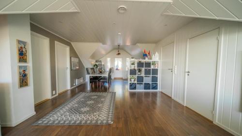 a living room with a hard wood floor and a ceiling at Large and great loft in scenic surroundings in Alta