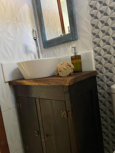 a bathroom sink on top of a wooden cabinet at Casa de Praia Itacimirim Bahia - Piscina e Conforto in Camacari