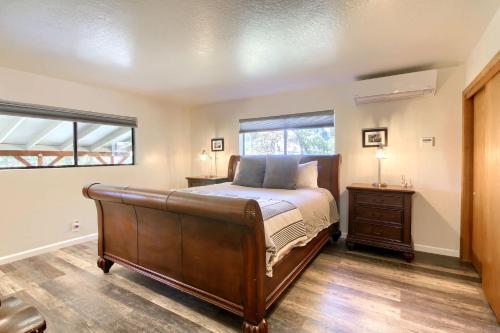a bedroom with a large bed and a window at Waterfall House-Riverfront-Bbq-sleeps Four in Oakhurst