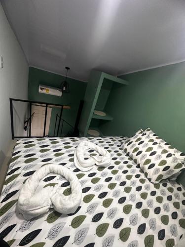 a bedroom with two snakes laying on a bed at The Jungle Container in Quepos