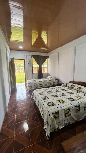 a bedroom with two beds in a room at Cabinas Caño Negro in Los Chiles