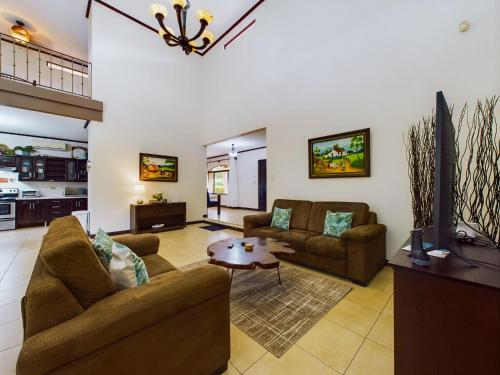 a living room with two couches and a table at Catalina Cove 3- 6 Bedroomloft Home in Brasilito