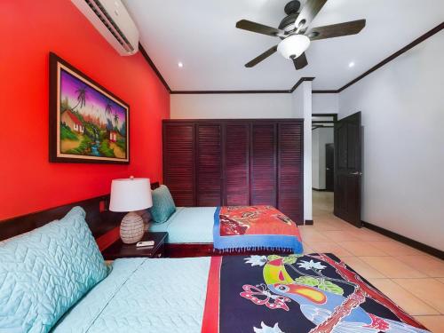 a bedroom with two beds and a ceiling fan at Catalina Cove 3- 6 Bedroomloft Home in Brasilito