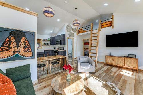 a living room with a tv and a couch and a table at Remote Home with Deck and Grill in Scenic Tuckasegee! in Tuckasegee