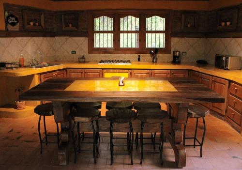 a kitchen with a large wooden table and stools at Rancho San Antonio in Salento