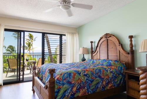 a bedroom with a bed with a view of the ocean at Kihei Akahi A104 in Wailea