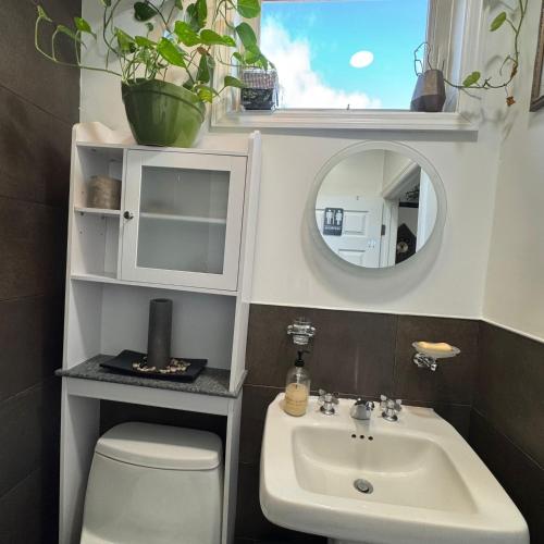 a bathroom with a sink and a toilet and a mirror at Dayton Dream in Newark