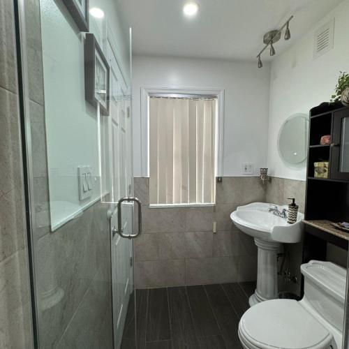 a bathroom with a shower and a toilet and a sink at Dayton Dream in Newark