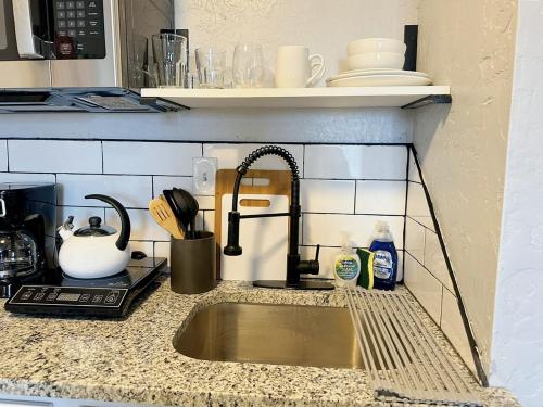 a kitchen counter with a sink and a microwave at Affordable Okc 1br Walk To Paseo Arts #20b in Oklahoma City