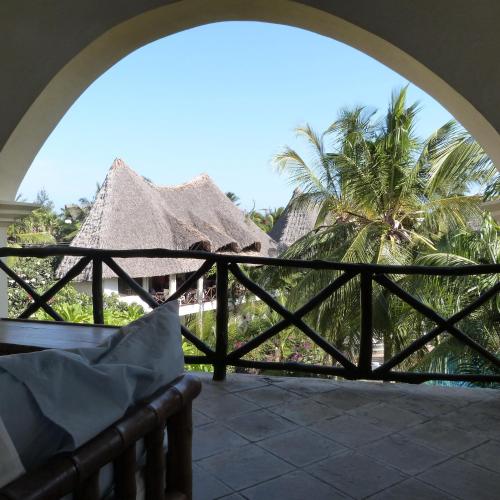a view from the balcony of a resort with palm trees at Aquarius Club in Watamu