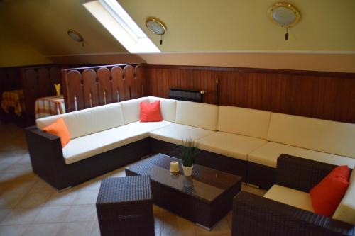 a living room with a couch and a table at Hotel Lukács Superior in Kazincbarcika