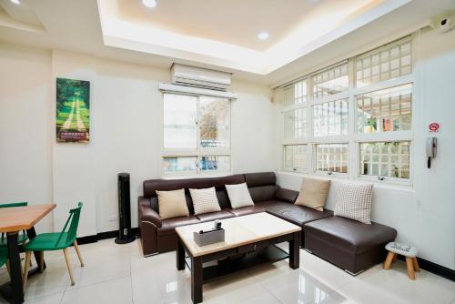 a living room with a couch and a table at 金華民宿 in Jincheng