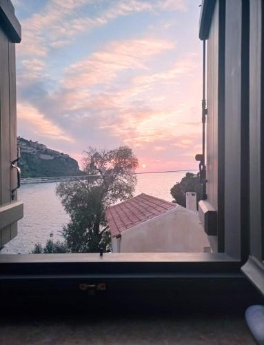 a window view of the water from a house at Vina's Stone House in Limeni